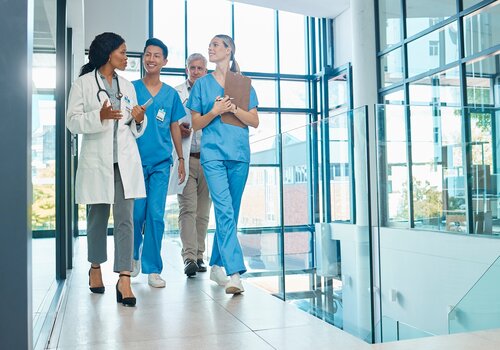 female provider with a group staff in a hospital setting
